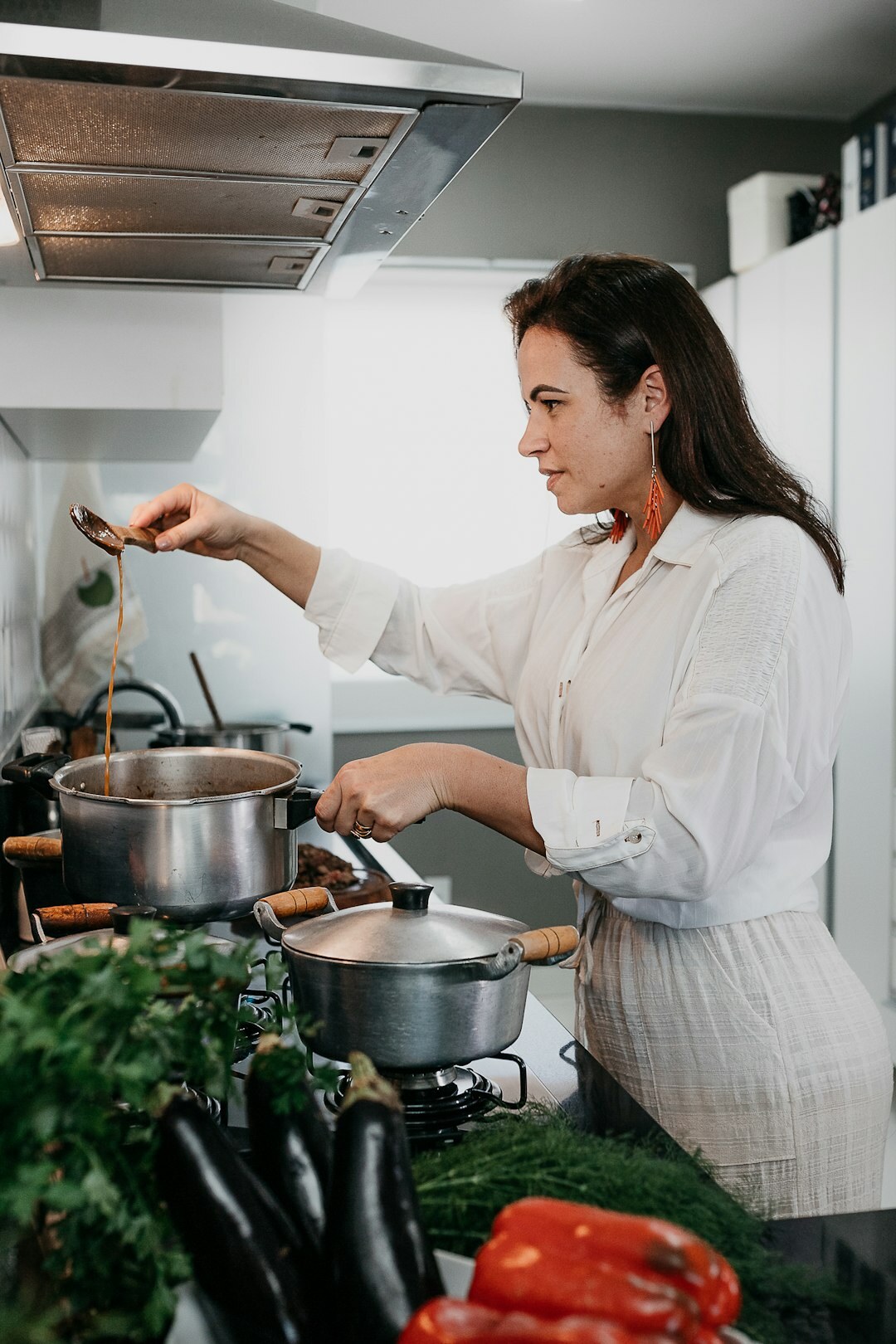 Home cook plating a finished dish in a bright kitchen