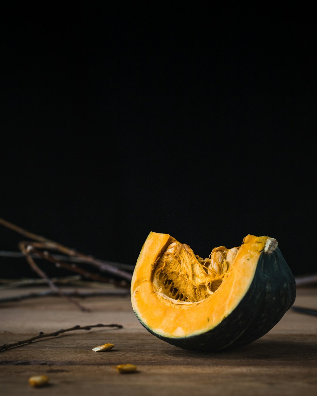 Pumpkin soup with roasted seeds on an autumn table