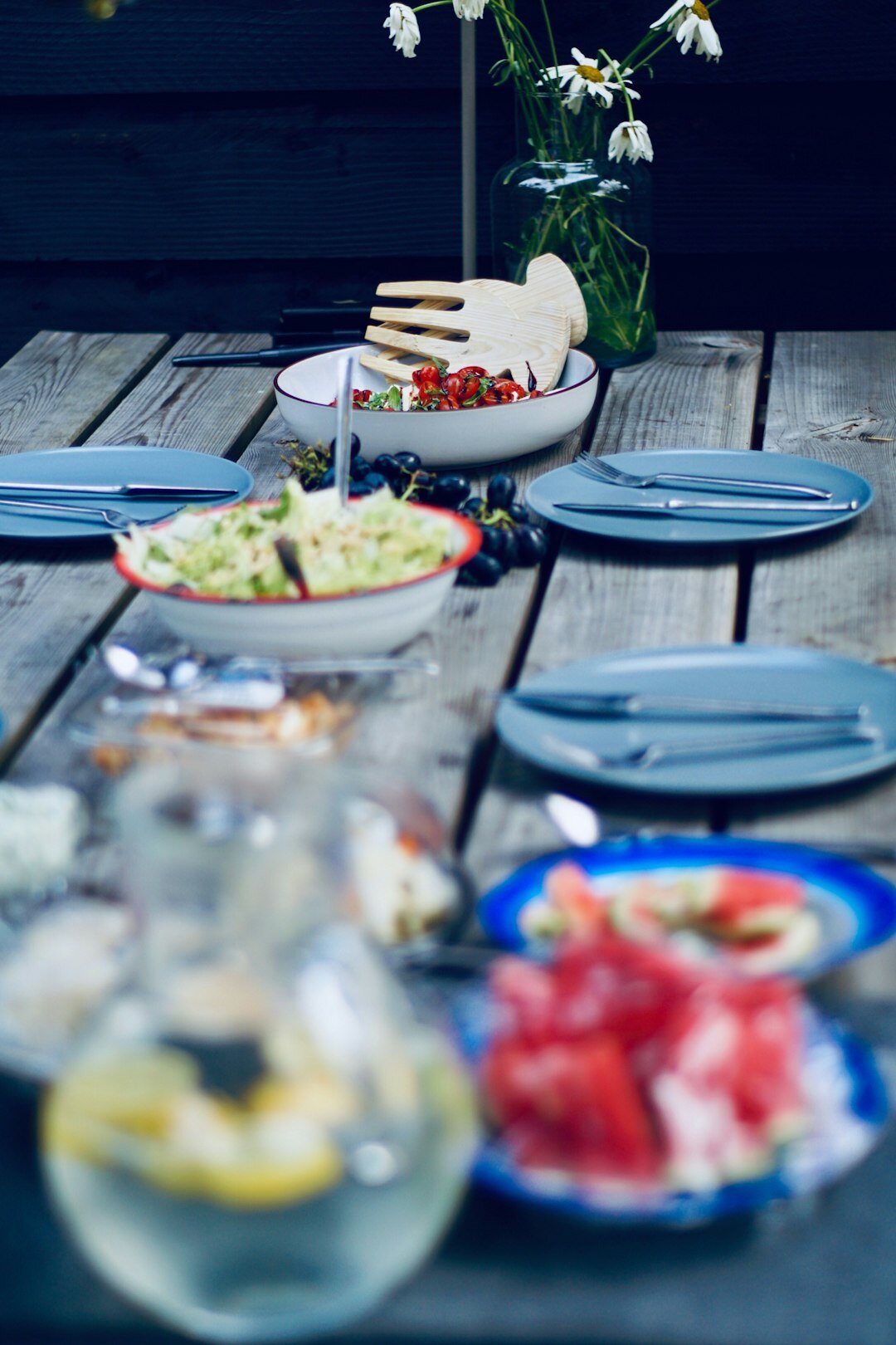 Fresh summer berries and salad ingredients on a garden table
