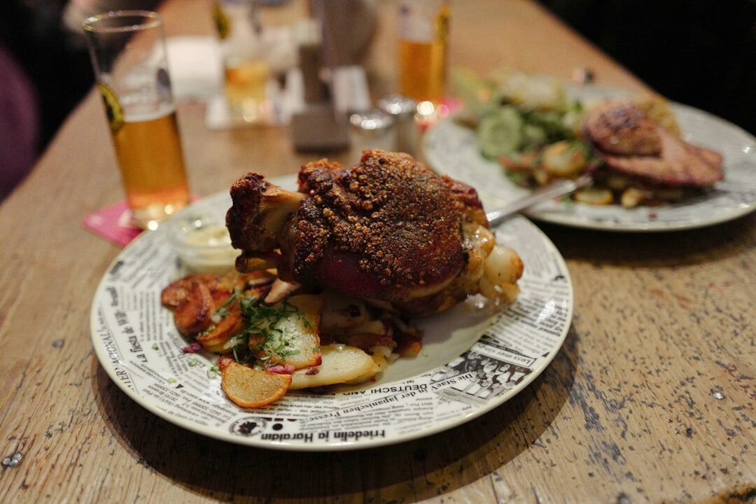 Roasted pork knee with dumplings and sauerkraut on a plate